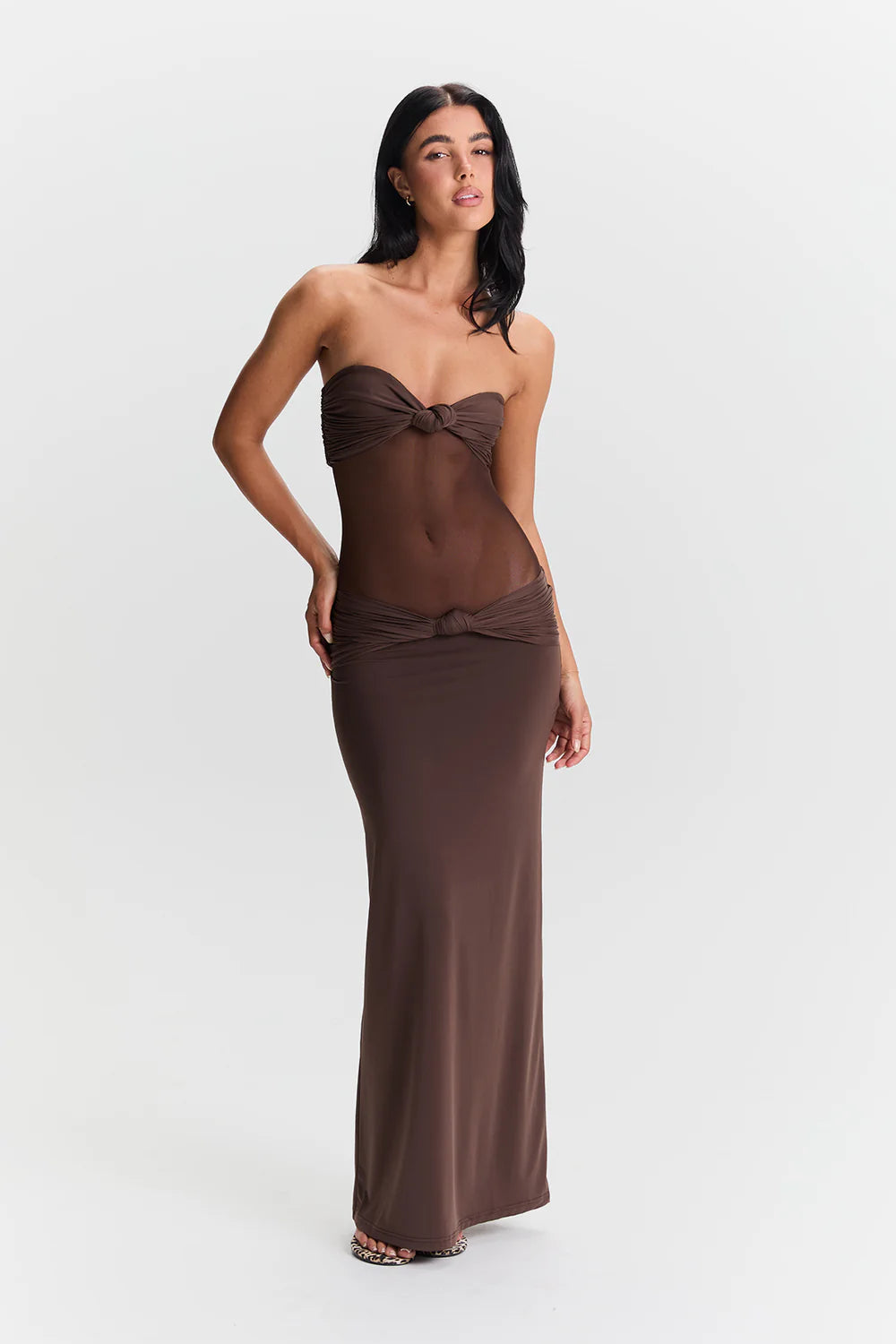 Sasha Therese Amara Maxi Dress in brown featuring halter neckline, front twist detail and fitted stretch jersey silhouette with floor length design