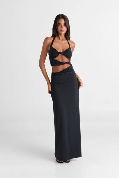 Sasha Therese Oralia Maxi Dress in black featuring halter neckline, twist front bust detail and elegant floor length silhouette with soft stretch jersey fabric