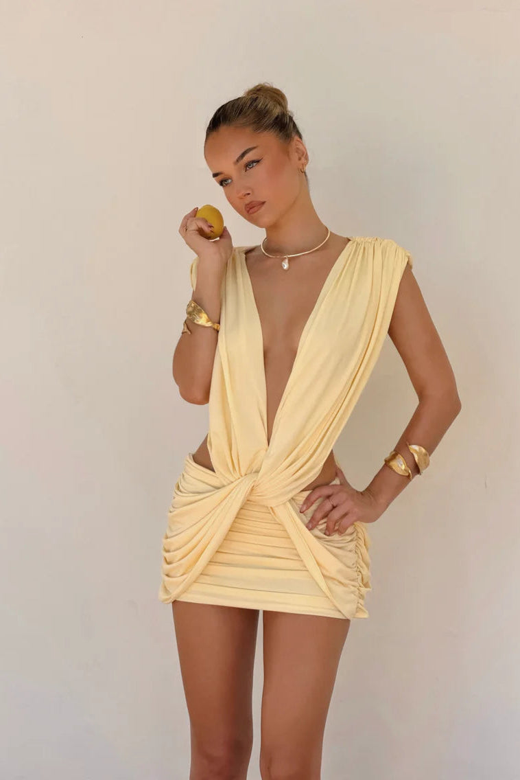 Vivienne Collection Lilou mini dress in baby yellow featuring deep V neckline, knotted waist detail and ruched bodycon silhouette