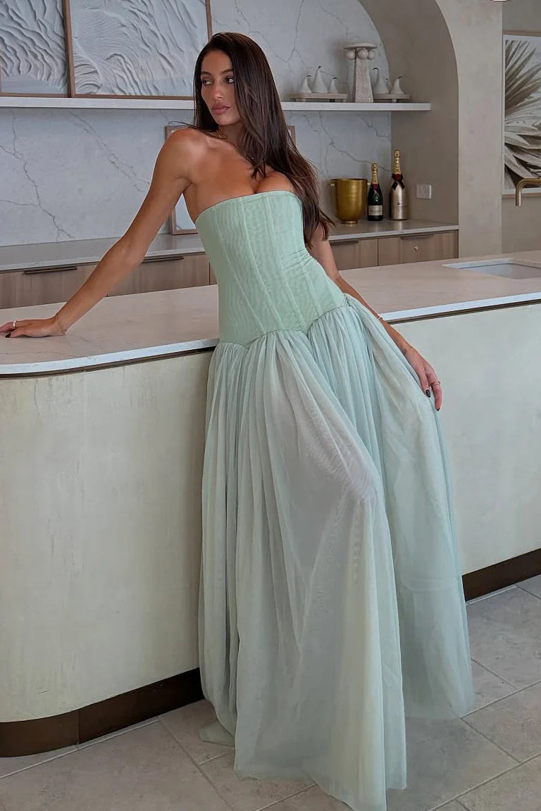 Mint green maxi dress showing drop waist design flowing into a voluminous layered skirt